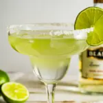 A perfectly crafted classic margarita in a salt-rimmed glass, garnished with a lime wheel, showcasing the best margarita recipe.