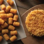 A side-by-side comparison of crispy tater tots and a golden hash brown patty, illustrating the Tater Tots vs Hash Browns debate.